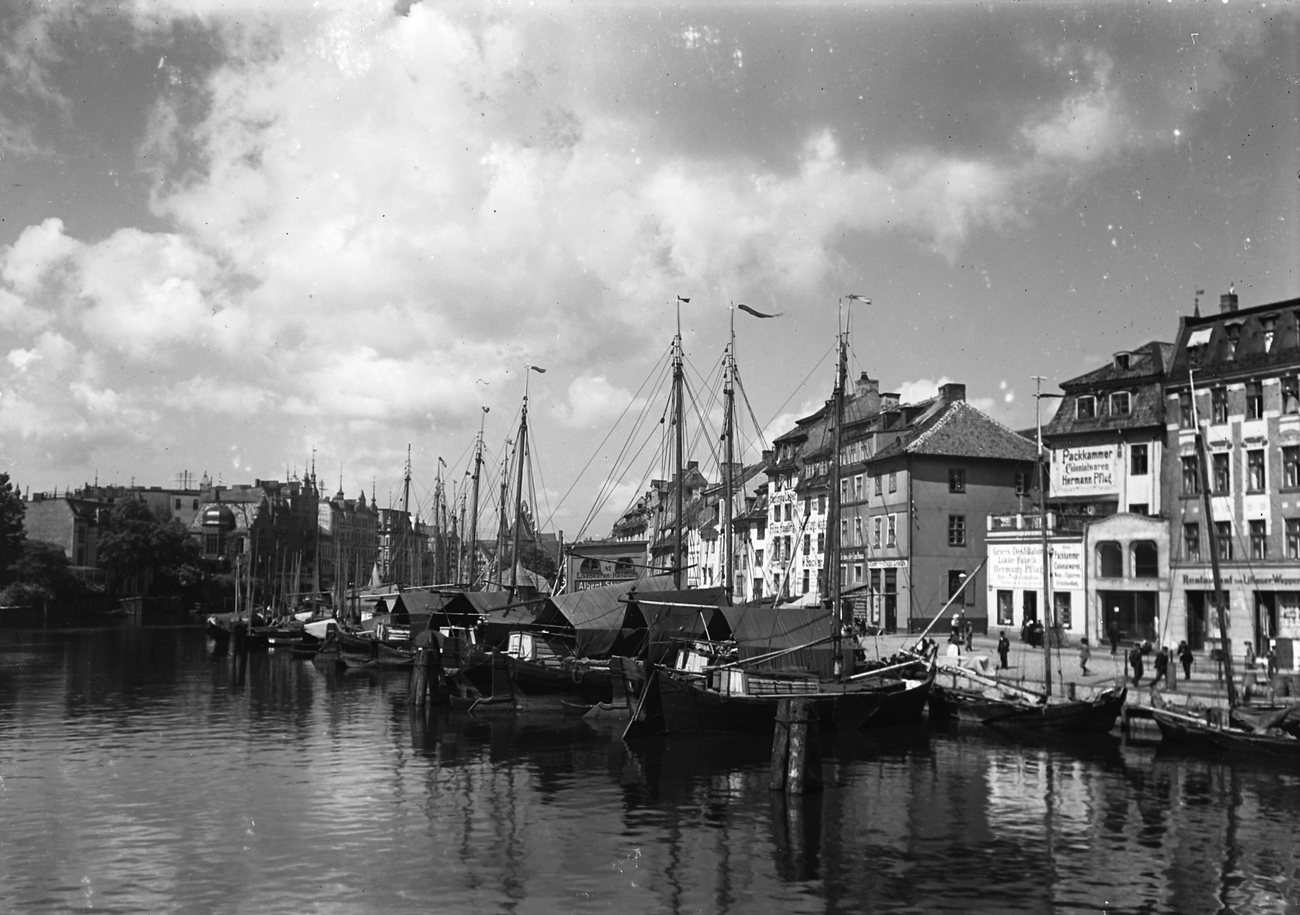 Sailing barges moored along the north bank of the New Pregel in Königsberg, today Kaliningrad, around 1900, under a sky full of clouds