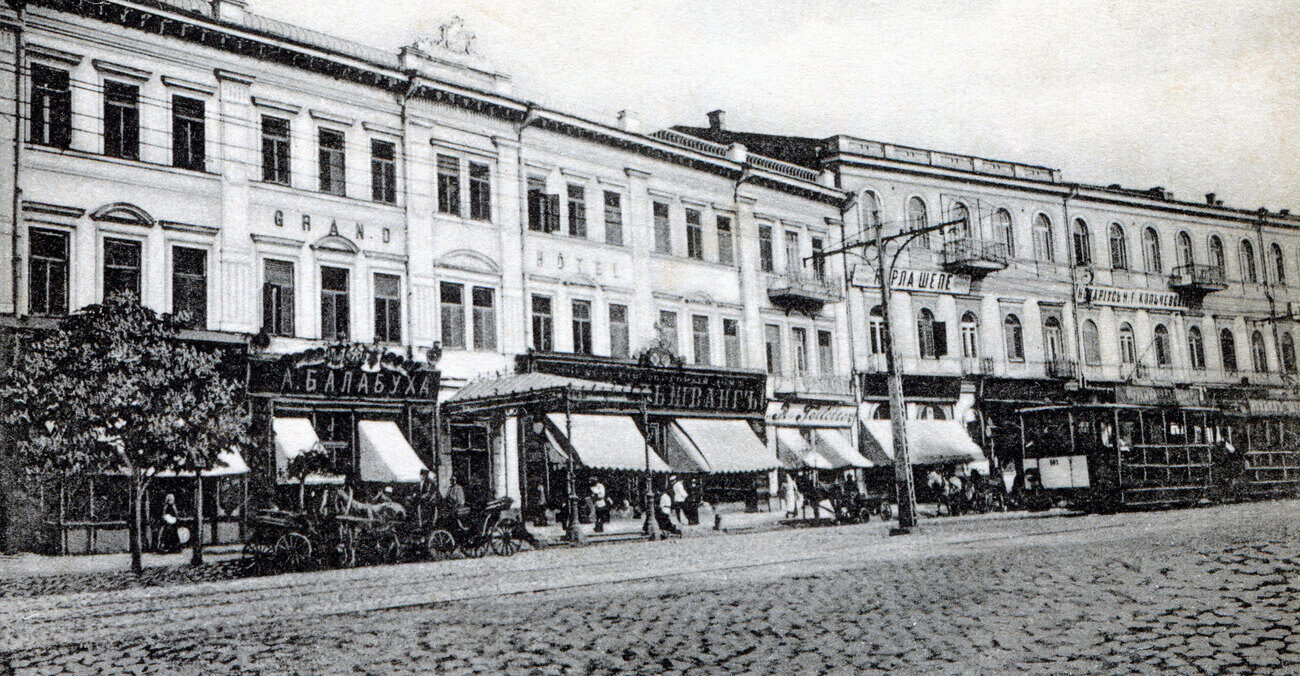 Shopfronts, awnings and a tram outside the Grand Hotel on Khreshchatyk, Kyiv, in the 1900s