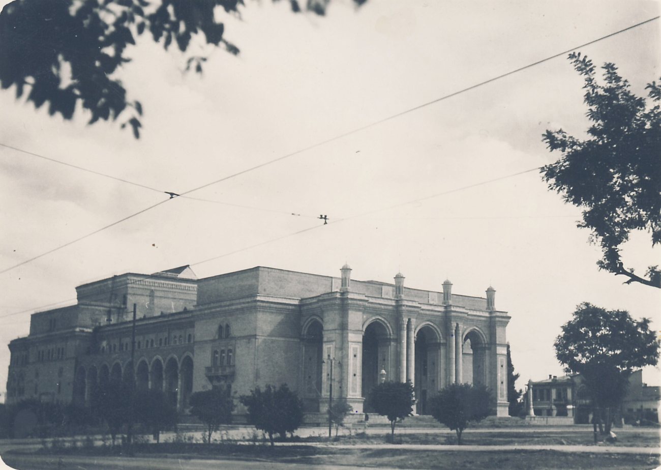 The arcaded front of the new Navoi Theatre in Tashkent in 1947–1948, behind young trees and overhead wires