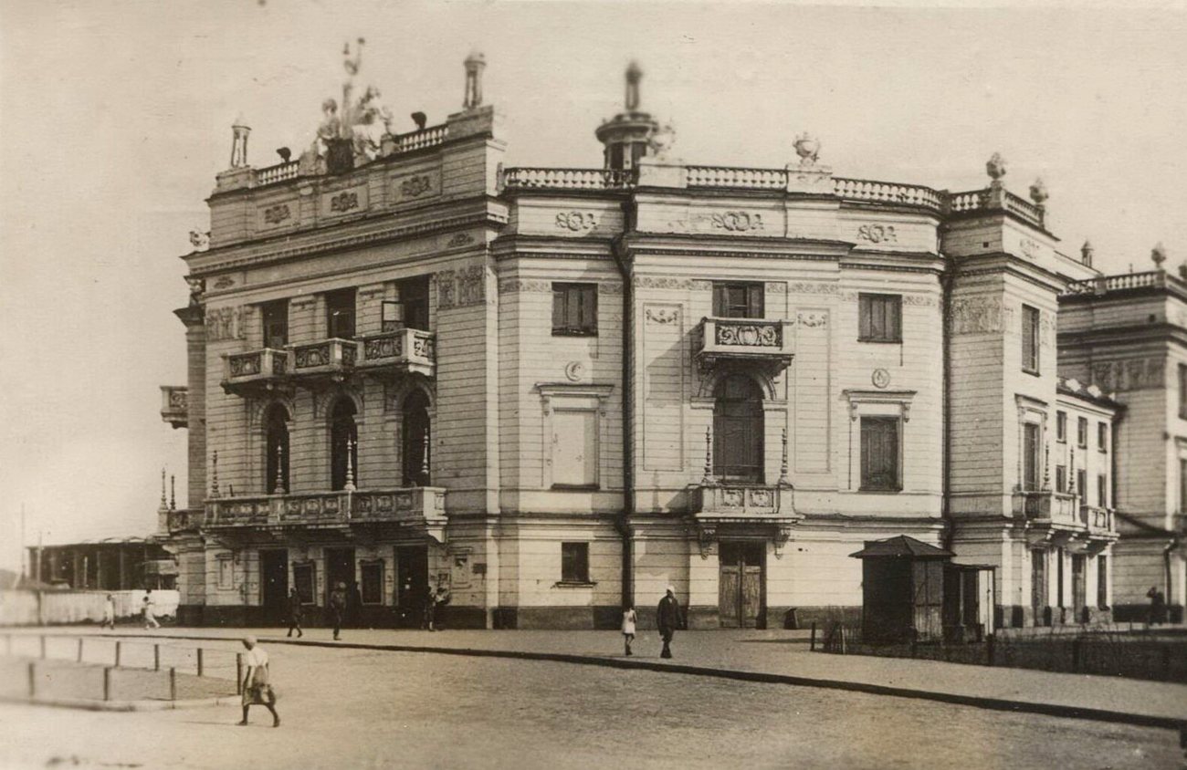Passers-by outside the ornate, sculpture-topped Opera House in Sverdlovsk, today Yekaterinburg, around 1930