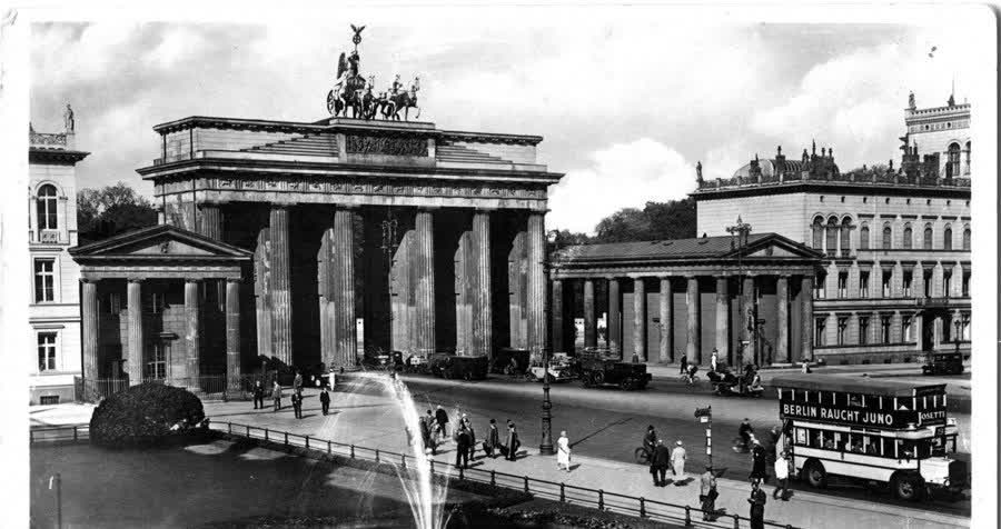 The Brandenburg Gate and Pariser Platz in Berlin, 1918, with a fountain, double-decker buses and pedestrians