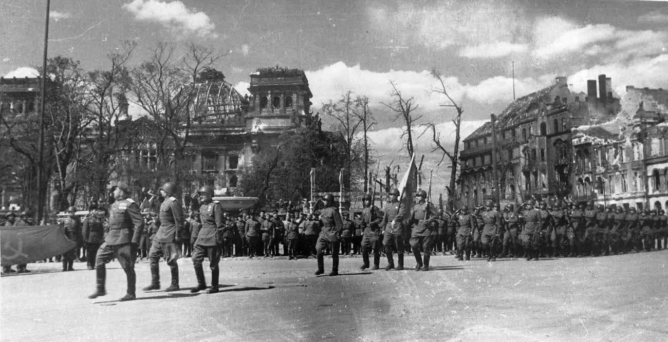 Soviet troops parading amid the ruins near the Reichstag in Berlin, 1945