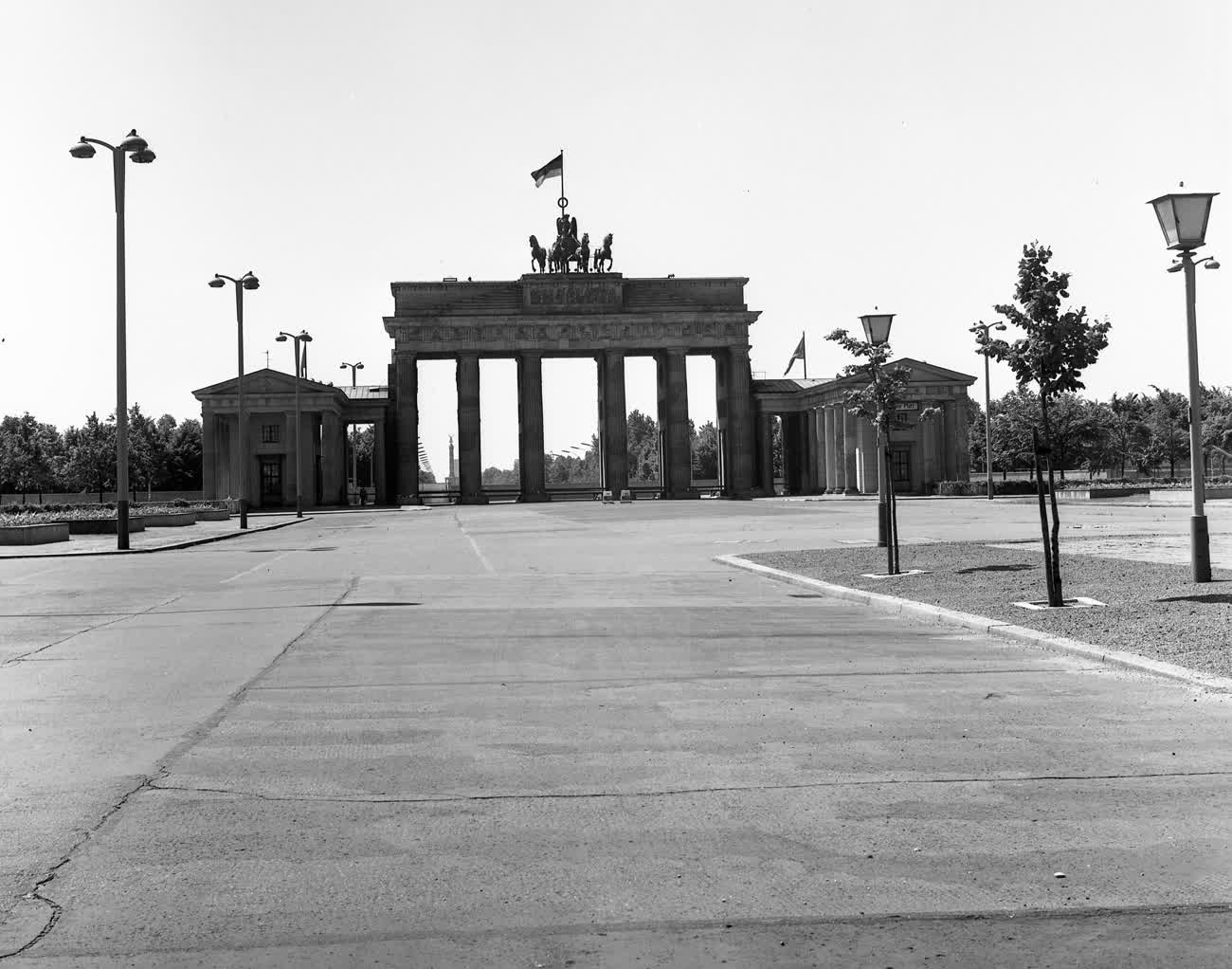 The Brandenburg Gate seen from East Berlin in 1970, empty, with an East German flag on top