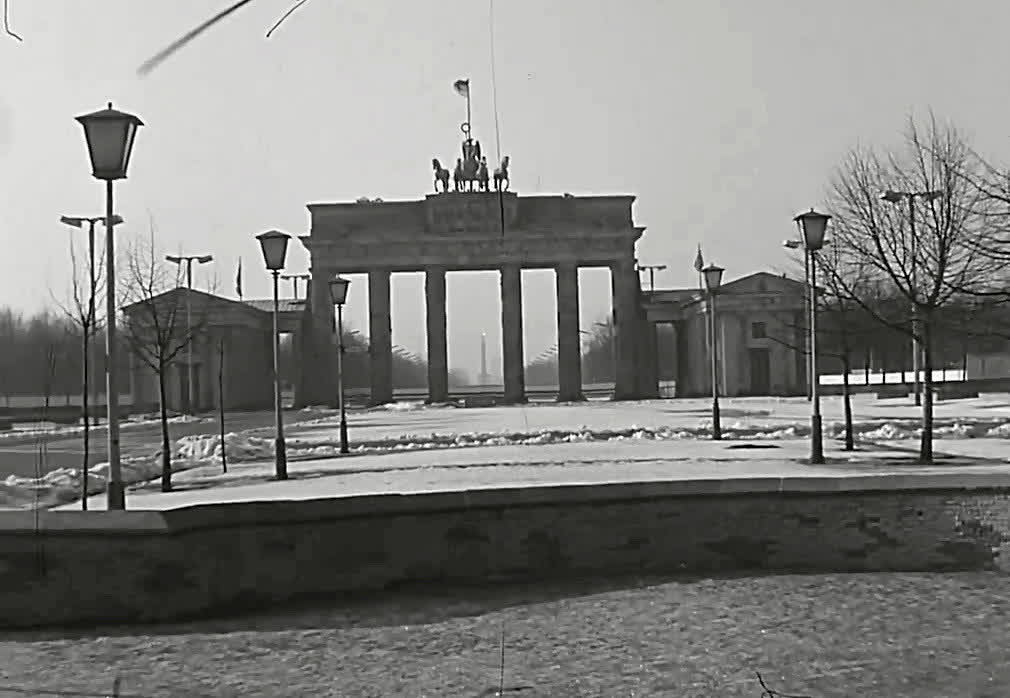 The Berlin Wall curving in front of the Brandenburg Gate in winter, 1981